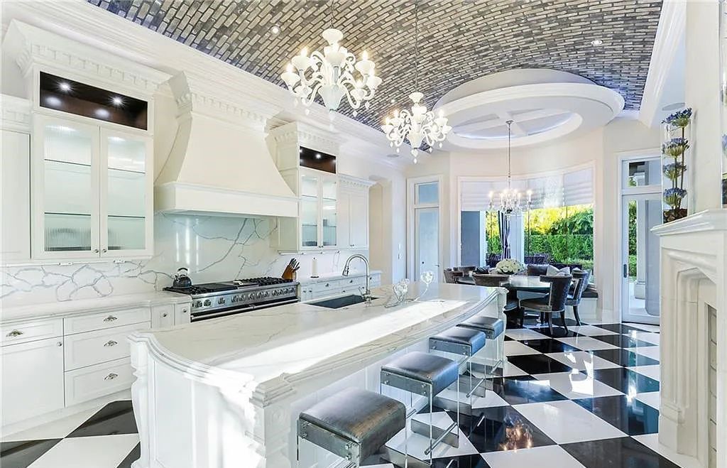 482 Ridge Drive, Naples, Florida, is located in a desirable Naples neighborhood, just minutes from Vanderbilt Beach, Mercato, and Waterside shops. This stunning home was built with meticulous attention to detail, including a butterfly staircase and marble floors.