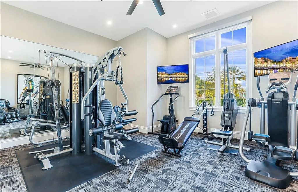 482 Ridge Drive, Naples, Florida, is located in a desirable Naples neighborhood, just minutes from Vanderbilt Beach, Mercato, and Waterside shops. This stunning home was built with meticulous attention to detail, including a butterfly staircase and marble floors.