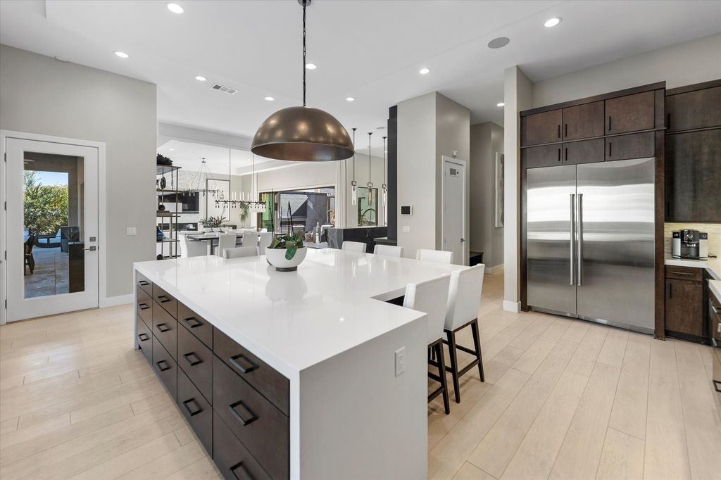 11448 Opal Springs Way, Las Vegas, Nevada is a guard-gated designer dream home with updated amenities including French oak hardwood flooring, silver travertine decking, closets, light fixtures, Control4 home automation, whole-home sound, and more.