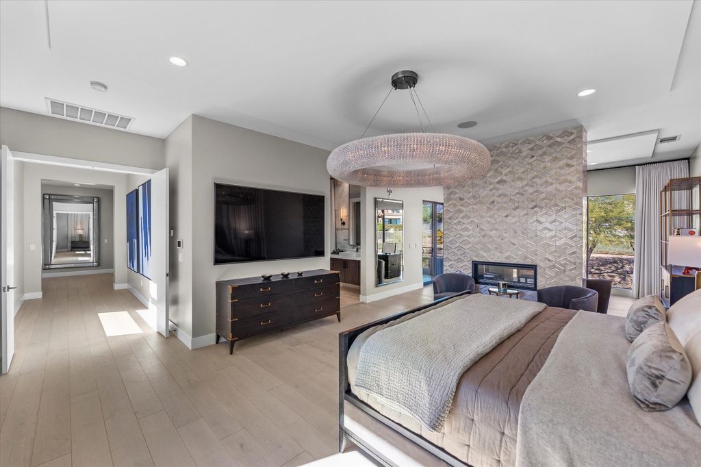 11448 Opal Springs Way, Las Vegas, Nevada is a guard-gated designer dream home with updated amenities including French oak hardwood flooring, silver travertine decking, closets, light fixtures, Control4 home automation, whole-home sound, and more.