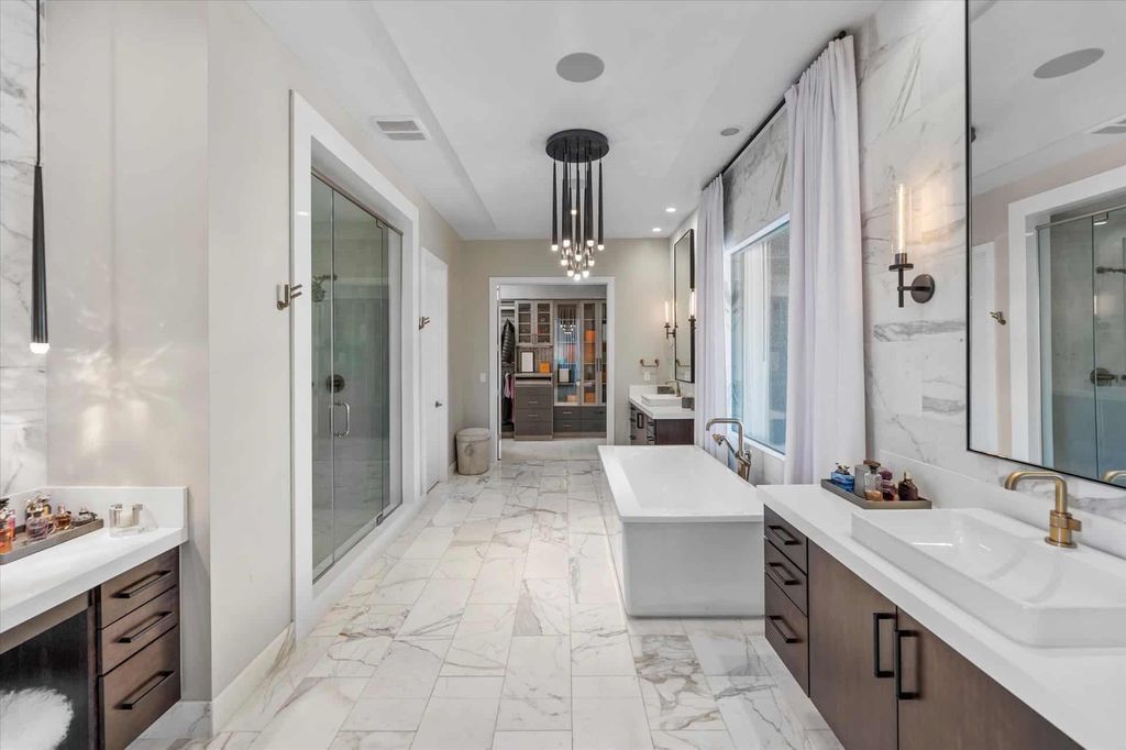 11448 Opal Springs Way, Las Vegas, Nevada is a guard-gated designer dream home with updated amenities including French oak hardwood flooring, silver travertine decking, closets, light fixtures, Control4 home automation, whole-home sound, and more.