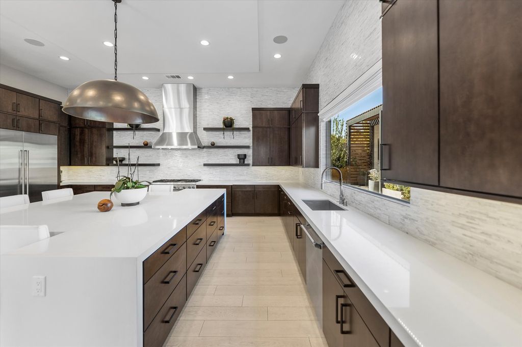 11448 Opal Springs Way, Las Vegas, Nevada is a guard-gated designer dream home with updated amenities including French oak hardwood flooring, silver travertine decking, closets, light fixtures, Control4 home automation, whole-home sound, and more.