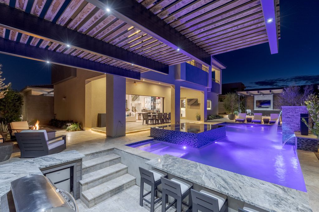 11448 Opal Springs Way, Las Vegas, Nevada is a guard-gated designer dream home with updated amenities including French oak hardwood flooring, silver travertine decking, closets, light fixtures, Control4 home automation, whole-home sound, and more.