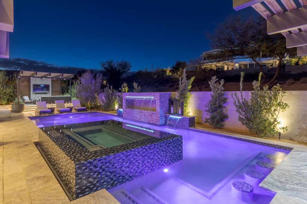 11448 Opal Springs Way, Las Vegas, Nevada is a guard-gated designer dream home with updated amenities including French oak hardwood flooring, silver travertine decking, closets, light fixtures, Control4 home automation, whole-home sound, and more.
