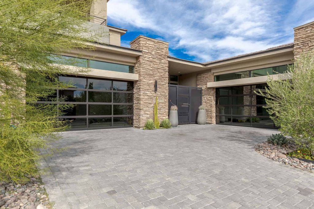 11448 Opal Springs Way, Las Vegas, Nevada is a guard-gated designer dream home with updated amenities including French oak hardwood flooring, silver travertine decking, closets, light fixtures, Control4 home automation, whole-home sound, and more.