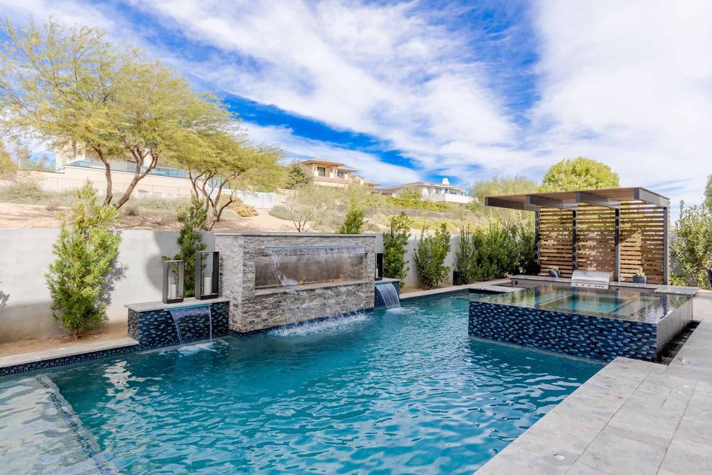 11448 Opal Springs Way, Las Vegas, Nevada is a guard-gated designer dream home with updated amenities including French oak hardwood flooring, silver travertine decking, closets, light fixtures, Control4 home automation, whole-home sound, and more.