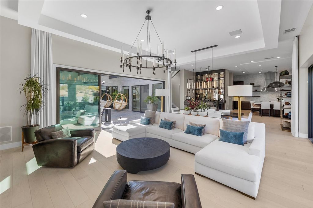11448 Opal Springs Way, Las Vegas, Nevada is a guard-gated designer dream home with updated amenities including French oak hardwood flooring, silver travertine decking, closets, light fixtures, Control4 home automation, whole-home sound, and more.