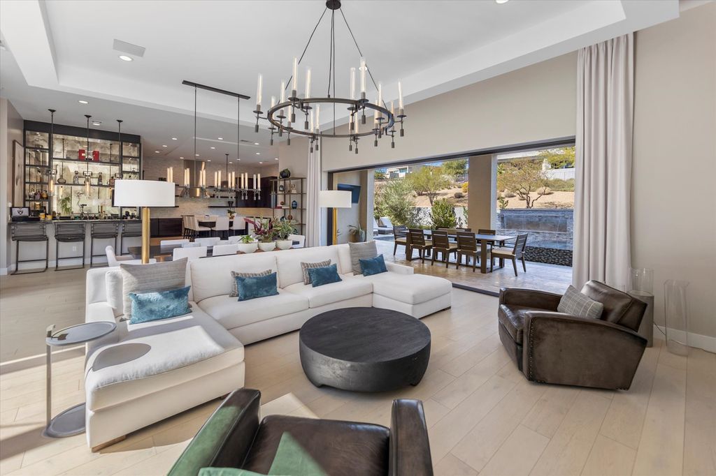 11448 Opal Springs Way, Las Vegas, Nevada is a guard-gated designer dream home with updated amenities including French oak hardwood flooring, silver travertine decking, closets, light fixtures, Control4 home automation, whole-home sound, and more.