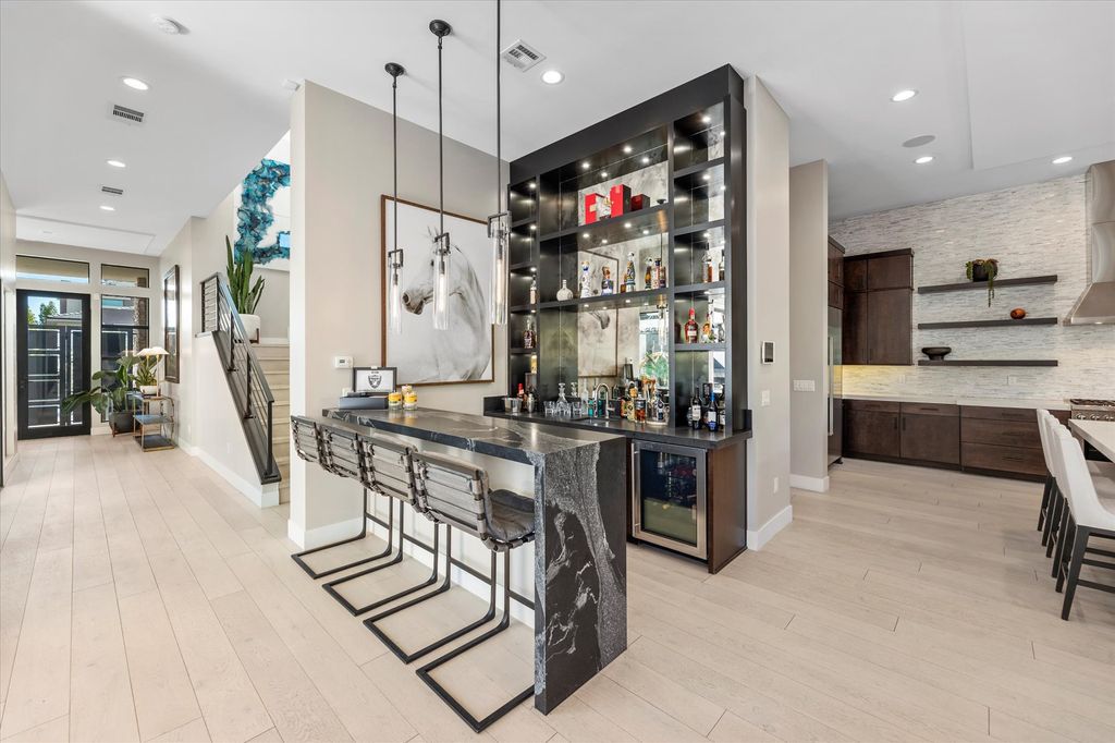11448 Opal Springs Way, Las Vegas, Nevada is a guard-gated designer dream home with updated amenities including French oak hardwood flooring, silver travertine decking, closets, light fixtures, Control4 home automation, whole-home sound, and more.