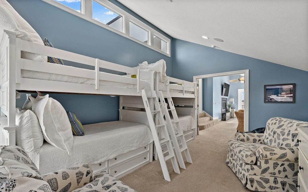 4600 Bay Point Road, Panama City Beach, Florida, is an exceptionally luxurious home with a Tropical Poolside Oasis with smart furnishings, soaring vaulted wood beam ceilings, a curving staircase, and an expansive living room featuring a well-appointed fireplace and triple French doors that lead to the elevated deck. This Home in Panama City Beach offers 6 bedrooms and 8 bathrooms with over 6.000 square feet of living spaces.
