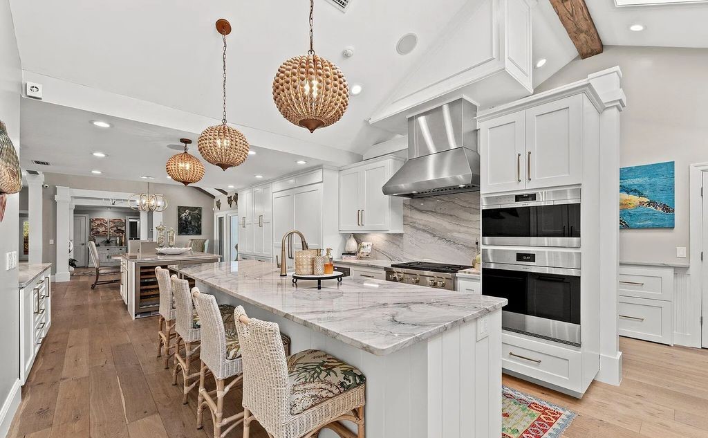 4600 Bay Point Road, Panama City Beach, Florida, is an exceptionally luxurious home with a Tropical Poolside Oasis with smart furnishings, soaring vaulted wood beam ceilings, a curving staircase, and an expansive living room featuring a well-appointed fireplace and triple French doors that lead to the elevated deck. This Home in Panama City Beach offers 6 bedrooms and 8 bathrooms with over 6.000 square feet of living spaces.