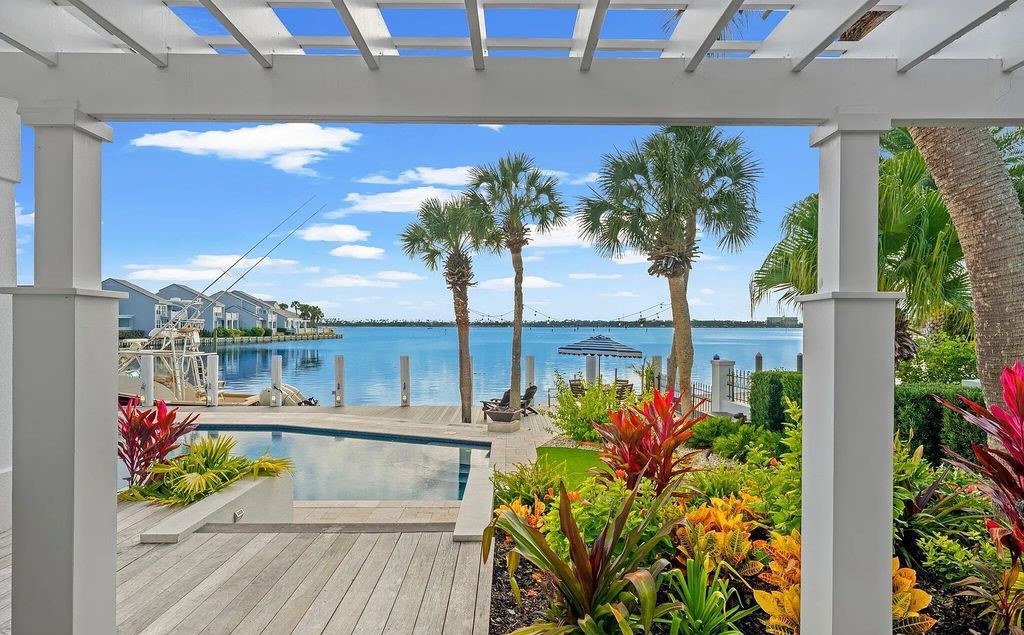 4600 Bay Point Road, Panama City Beach, Florida, is an exceptionally luxurious home with a Tropical Poolside Oasis with smart furnishings, soaring vaulted wood beam ceilings, a curving staircase, and an expansive living room featuring a well-appointed fireplace and triple French doors that lead to the elevated deck. This Home in Panama City Beach offers 6 bedrooms and 8 bathrooms with over 6.000 square feet of living spaces.