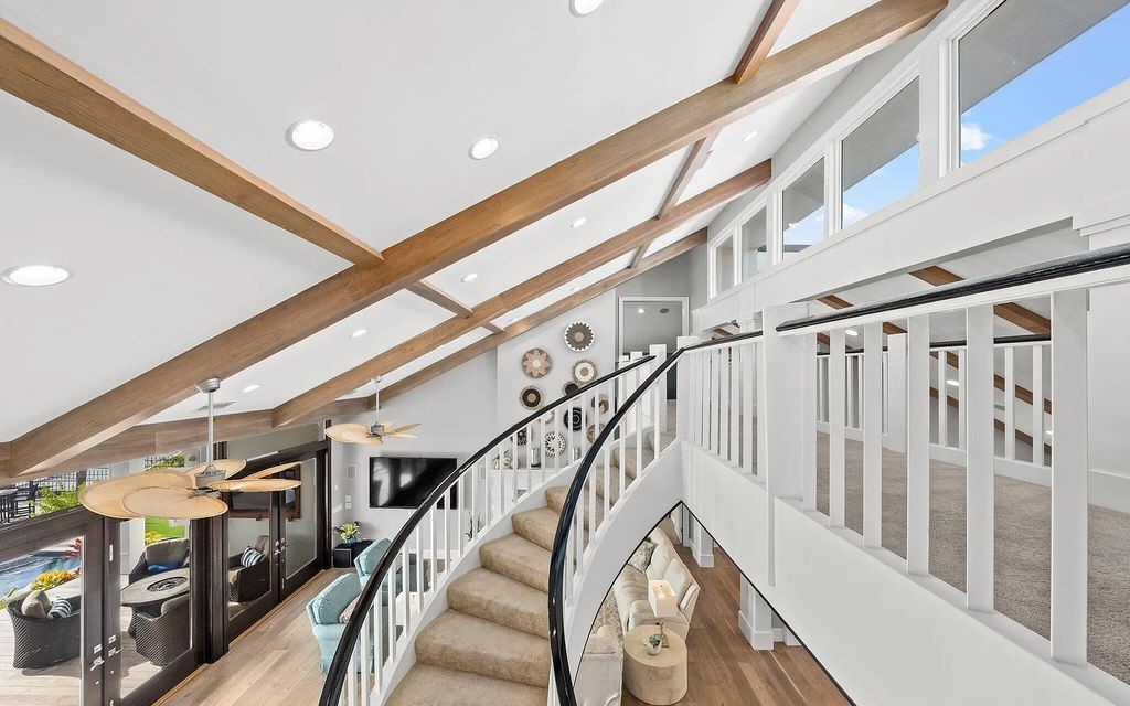 4600 Bay Point Road, Panama City Beach, Florida, is an exceptionally luxurious home with a Tropical Poolside Oasis with smart furnishings, soaring vaulted wood beam ceilings, a curving staircase, and an expansive living room featuring a well-appointed fireplace and triple French doors that lead to the elevated deck. This Home in Panama City Beach offers 6 bedrooms and 8 bathrooms with over 6.000 square feet of living spaces.