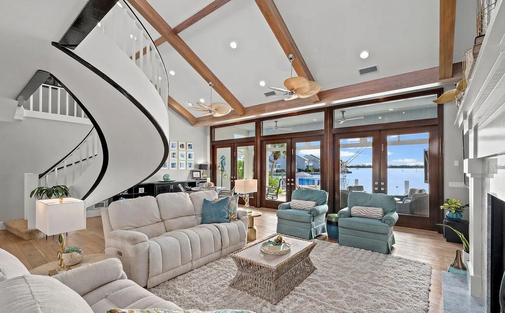 4600 Bay Point Road, Panama City Beach, Florida, is an exceptionally luxurious home with a Tropical Poolside Oasis with smart furnishings, soaring vaulted wood beam ceilings, a curving staircase, and an expansive living room featuring a well-appointed fireplace and triple French doors that lead to the elevated deck. This Home in Panama City Beach offers 6 bedrooms and 8 bathrooms with over 6.000 square feet of living spaces.