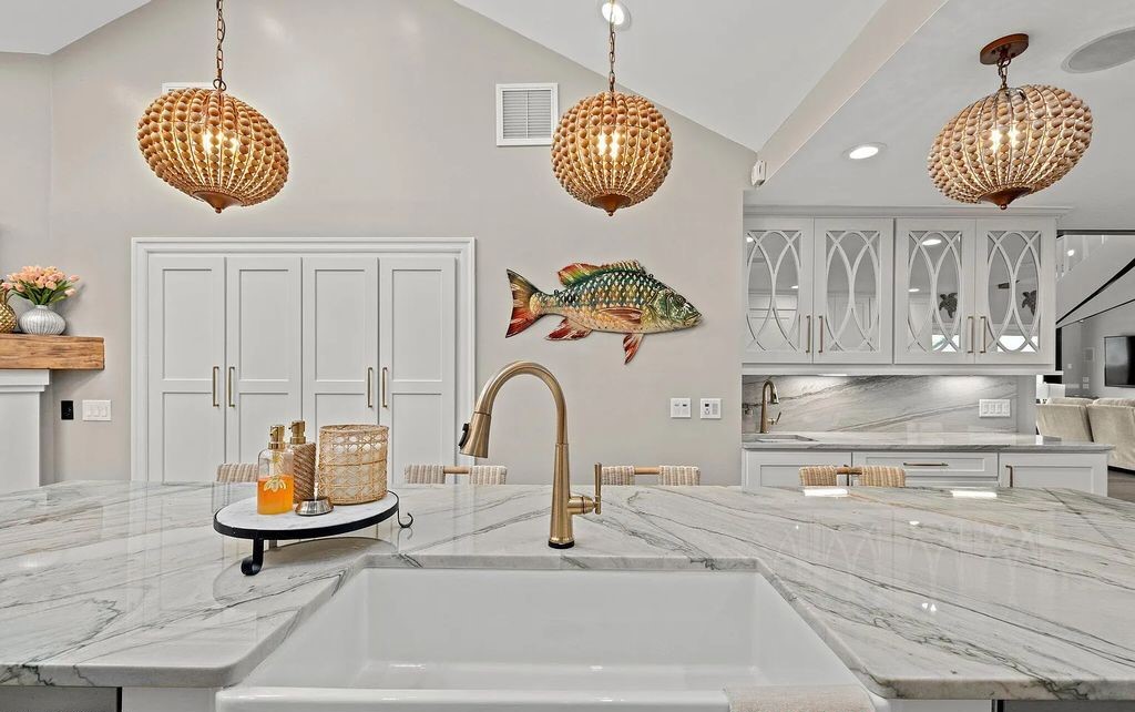 4600 Bay Point Road, Panama City Beach, Florida, is an exceptionally luxurious home with a Tropical Poolside Oasis with smart furnishings, soaring vaulted wood beam ceilings, a curving staircase, and an expansive living room featuring a well-appointed fireplace and triple French doors that lead to the elevated deck. This Home in Panama City Beach offers 6 bedrooms and 8 bathrooms with over 6.000 square feet of living spaces.