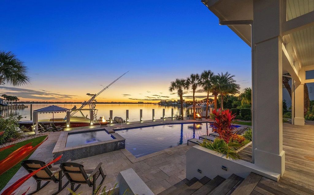 4600 Bay Point Road, Panama City Beach, Florida, is an exceptionally luxurious home with a Tropical Poolside Oasis with smart furnishings, soaring vaulted wood beam ceilings, a curving staircase, and an expansive living room featuring a well-appointed fireplace and triple French doors that lead to the elevated deck. This Home in Panama City Beach offers 6 bedrooms and 8 bathrooms with over 6.000 square feet of living spaces.
