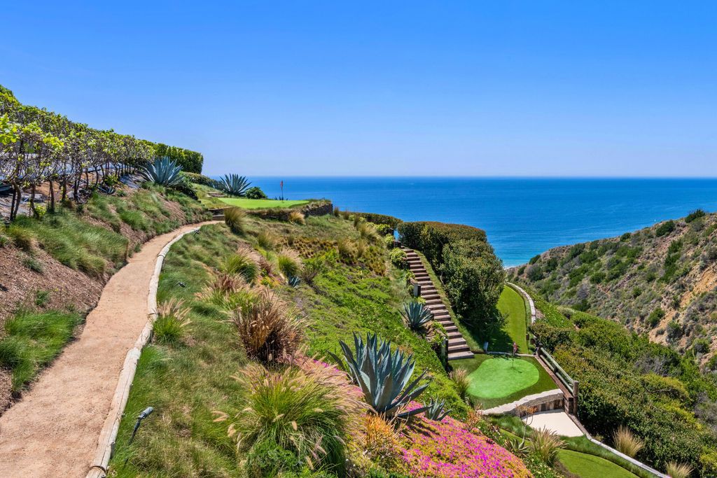 22407 Carbon Mesa Road, Malibu, California is truly a golfer's retreat in a spectacular, verdant setting on a gated promontory of more than two manicured acres on two parcels, views that take in a panorama of ocean, islands, and coastline from Point Dume and the Malibu Pier to Palos Verdes.