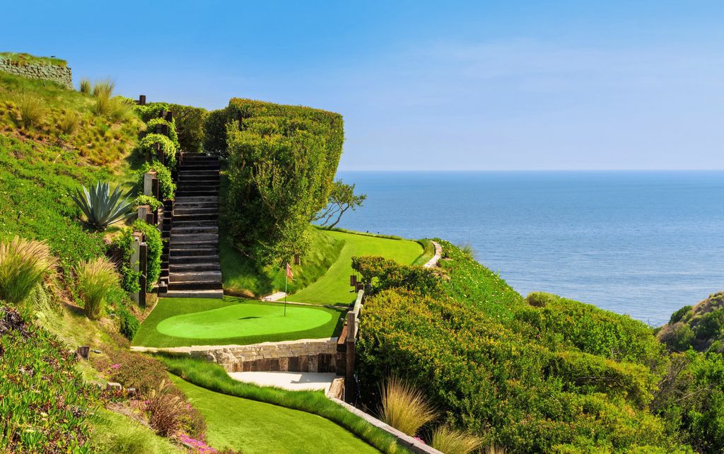 22407 Carbon Mesa Road, Malibu, California is truly a golfer's retreat in a spectacular, verdant setting on a gated promontory of more than two manicured acres on two parcels, views that take in a panorama of ocean, islands, and coastline from Point Dume and the Malibu Pier to Palos Verdes.