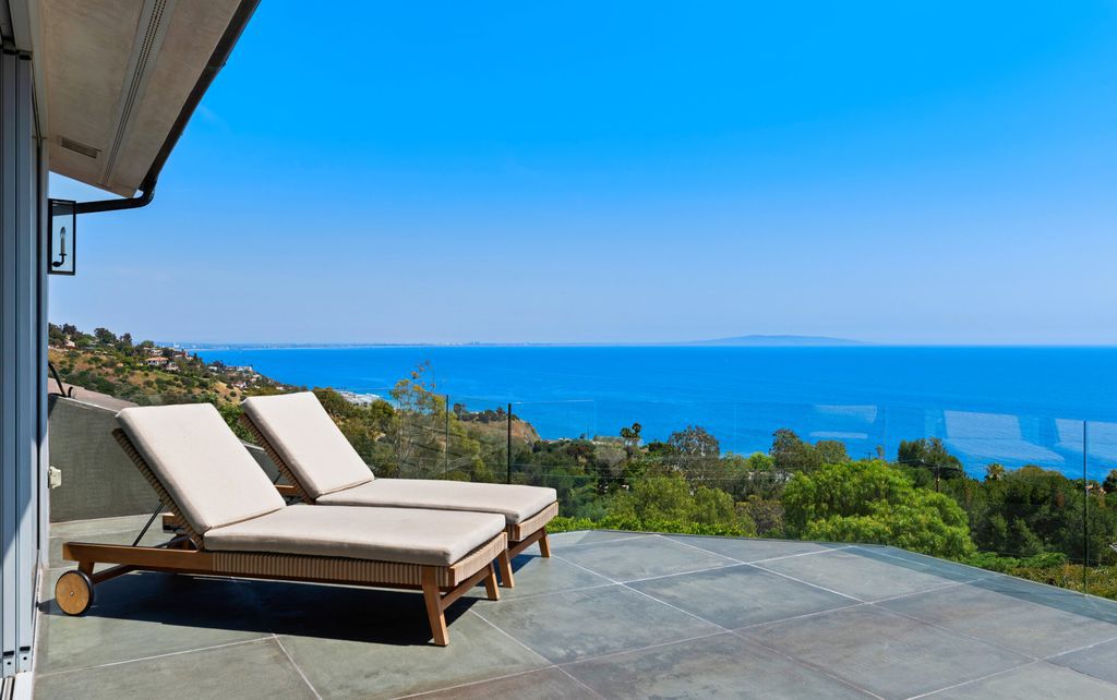 22407 Carbon Mesa Road, Malibu, California is truly a golfer's retreat in a spectacular, verdant setting on a gated promontory of more than two manicured acres on two parcels, views that take in a panorama of ocean, islands, and coastline from Point Dume and the Malibu Pier to Palos Verdes.