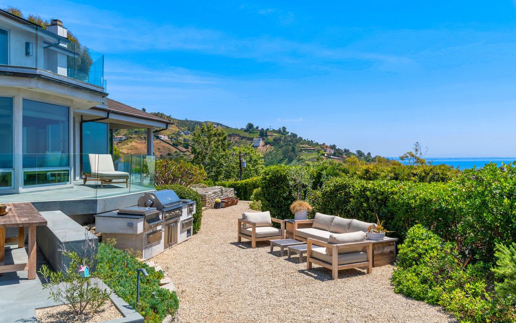 22407 Carbon Mesa Road, Malibu, California is truly a golfer's retreat in a spectacular, verdant setting on a gated promontory of more than two manicured acres on two parcels, views that take in a panorama of ocean, islands, and coastline from Point Dume and the Malibu Pier to Palos Verdes.