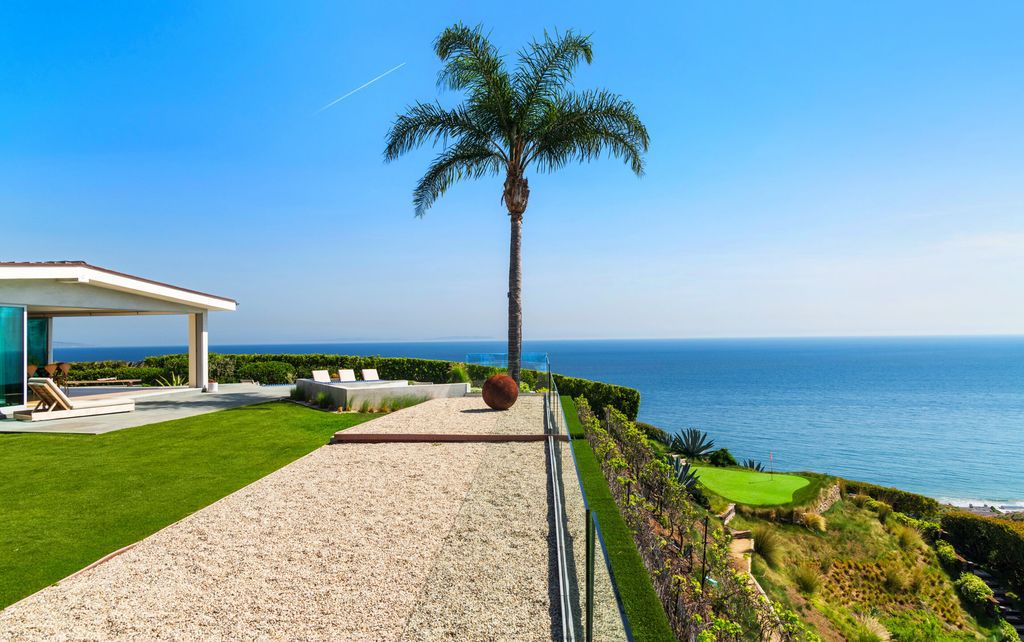 22407 Carbon Mesa Road, Malibu, California is truly a golfer's retreat in a spectacular, verdant setting on a gated promontory of more than two manicured acres on two parcels, views that take in a panorama of ocean, islands, and coastline from Point Dume and the Malibu Pier to Palos Verdes.