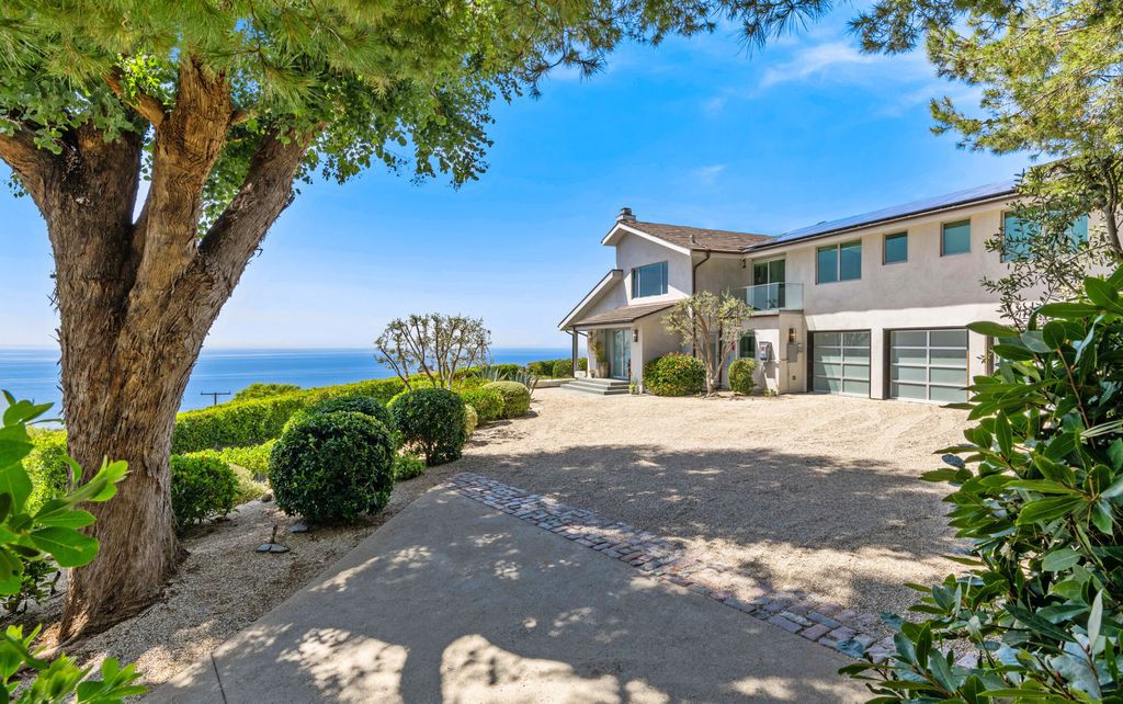 22407 Carbon Mesa Road, Malibu, California is truly a golfer's retreat in a spectacular, verdant setting on a gated promontory of more than two manicured acres on two parcels, views that take in a panorama of ocean, islands, and coastline from Point Dume and the Malibu Pier to Palos Verdes.