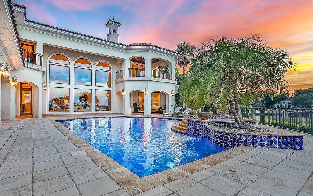 13897 Bella Riva Lane, Jacksonville, Florida, is located on the intracoastal waterway in prestigious Queen's Harbour and is perfect for formal or casual entertaining. The elegant, contemporary home has a 2-story layout with panoramic vistas of the Intracoastal and marshes, offering privacy and spectacular views.