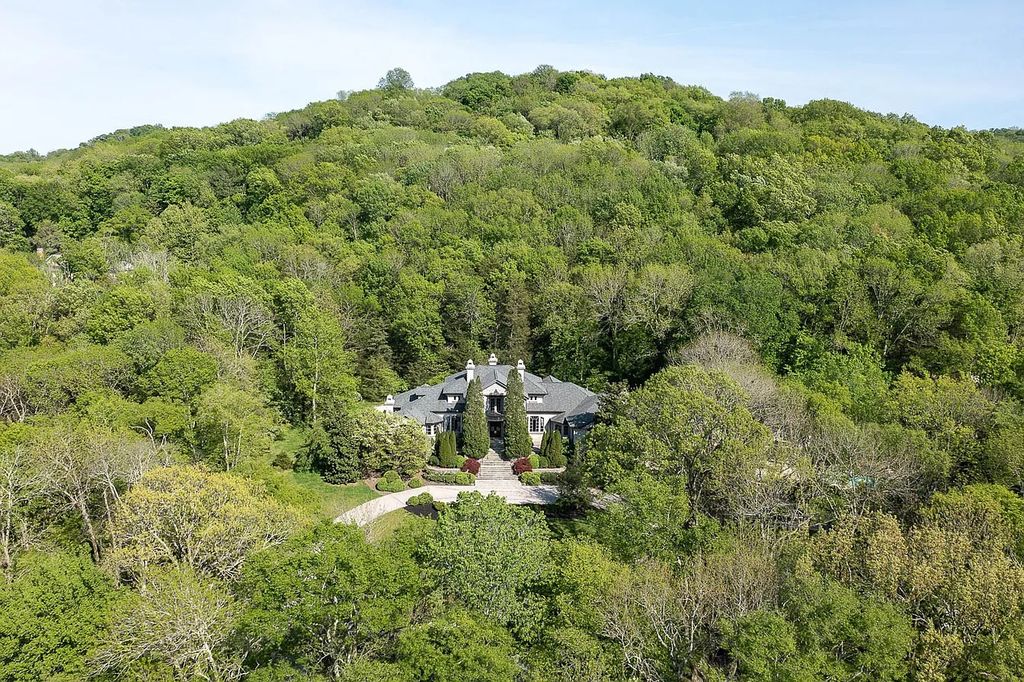 The Home in Nashville provides extensive landscaping throughout the property with dogwoods, hydrangeas and a meandering creek, now available for sale. This home located at 1310 Chickering Rd, Nashville, Tennessee