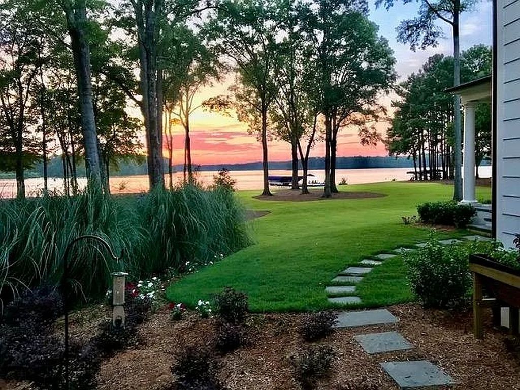The House in Eatonton boasts gorgeous landscaping and 180 degree views of Lake Oconee, now available for sale. This home located at 158 Bradford Dr, Eatonton, Georgia