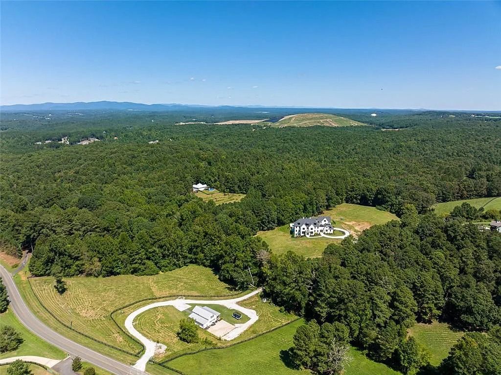 The House in Canton includes a Barndominium guest house, multiple creeks and fenced pastures perfect for horses, now available for sale. This home located at 1661 Harmony Dr, Canton, Georgia