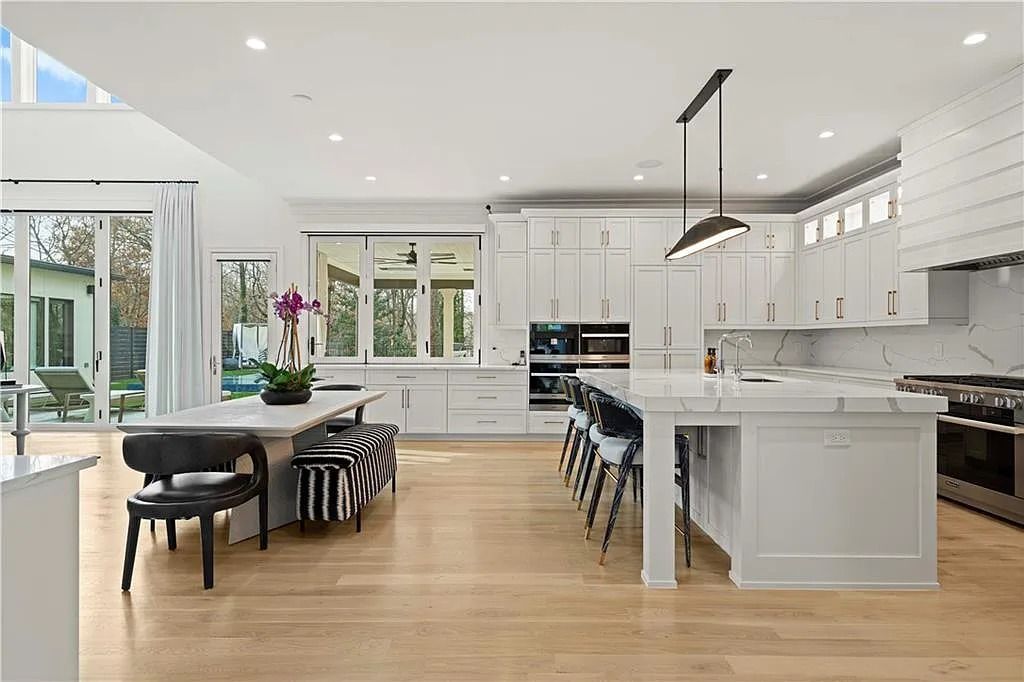 The Estate in Atlanta is a luxurious home with an open concept floor plan featuring gorgeous white oak hardwood flooring throughout, now available for sale. This home located at 1107 Moores Mill Rd NW, Atlanta, Georgia
