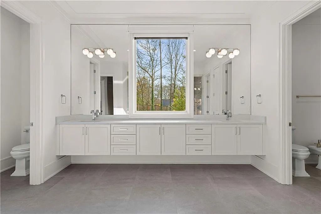 The Estate in Atlanta is a luxurious home with an open concept floor plan featuring gorgeous white oak hardwood flooring throughout, now available for sale. This home located at 1107 Moores Mill Rd NW, Atlanta, Georgia