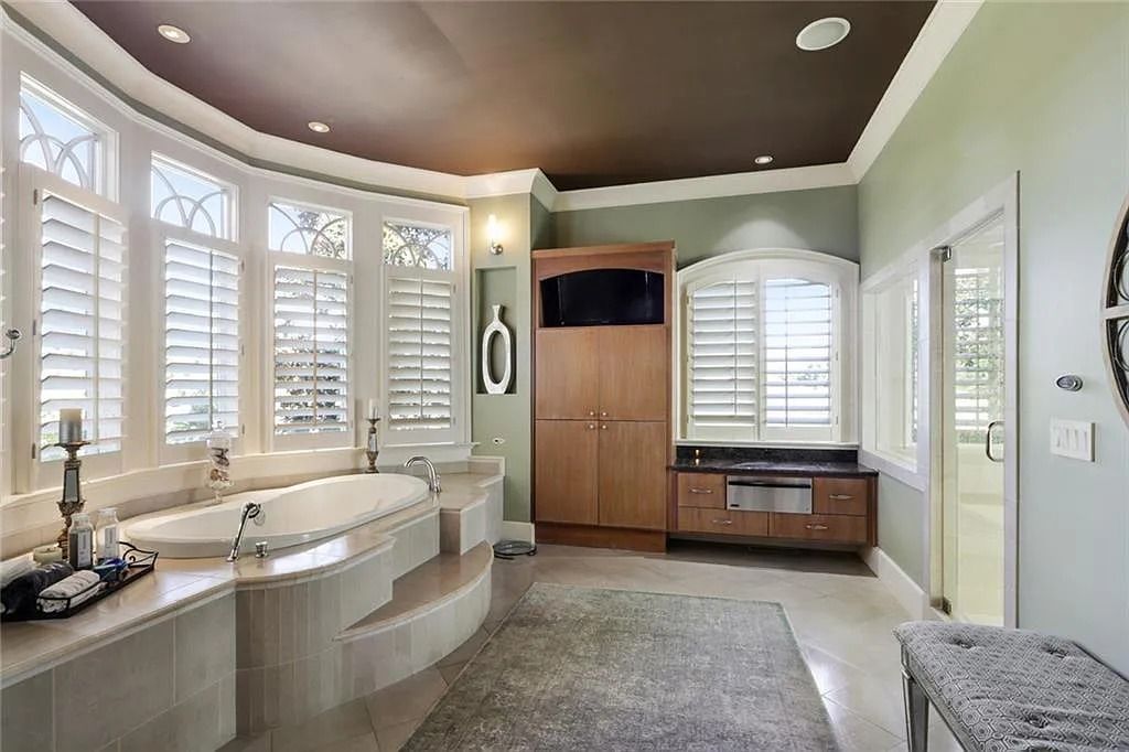 The Home in Kennesaw is the entertainers delight with large open spaces and a salt water pool with a connecting hot tub and wine cellar, now available for sale. This home located at 4235 Old Stilesboro Rd NW, Kennesaw, Georgia