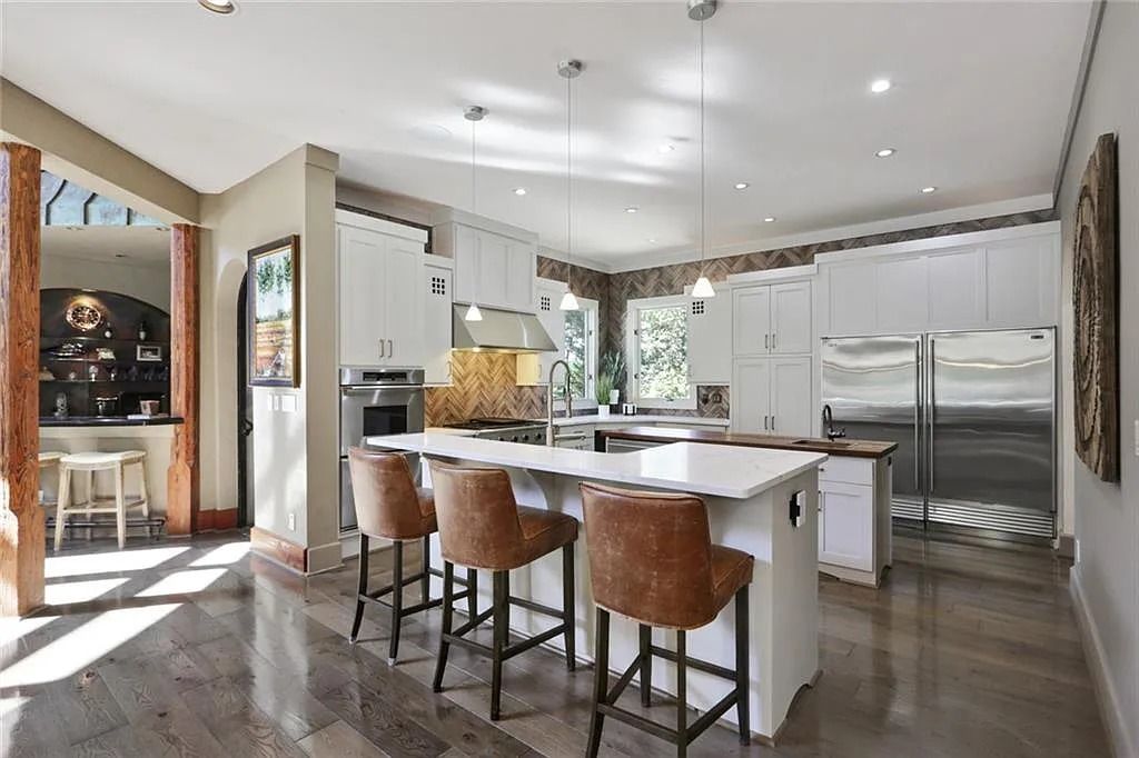 The Home in Kennesaw is the entertainers delight with large open spaces and a salt water pool with a connecting hot tub and wine cellar, now available for sale. This home located at 4235 Old Stilesboro Rd NW, Kennesaw, Georgia