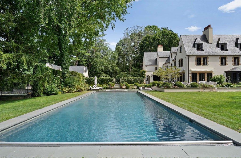 339 Duck Pond Road, Locust Valley, New York is a one of a kind home originally built in 1926 in the prestigious Village of Matinecock with exceptional amenities including a pool, pool house, tennis court, outdoor kitchen, gardens and terraces. elevator, nest system, 3,000 bottle wine cellar, art studio and more.