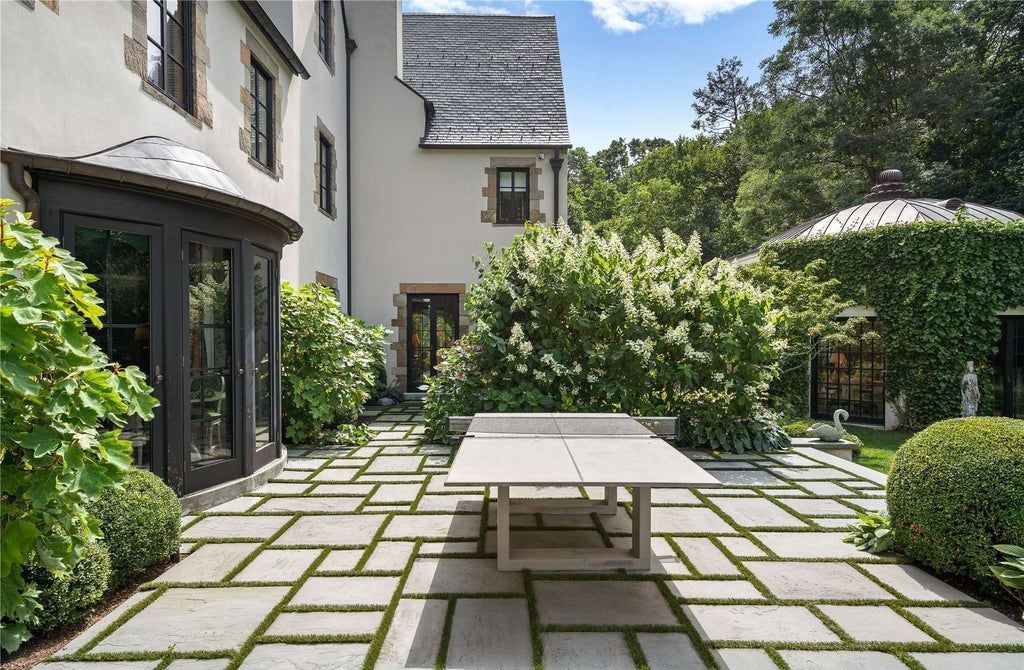 339 Duck Pond Road, Locust Valley, New York is a one of a kind home originally built in 1926 in the prestigious Village of Matinecock with exceptional amenities including a pool, pool house, tennis court, outdoor kitchen, gardens and terraces. elevator, nest system, 3,000 bottle wine cellar, art studio and more.