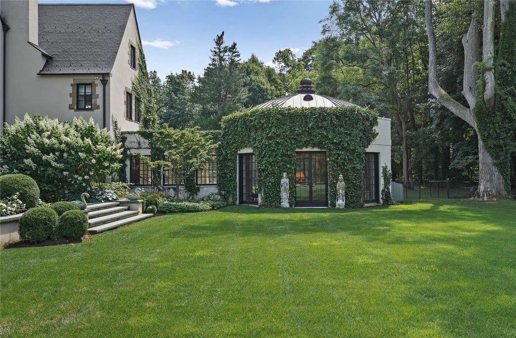 339 Duck Pond Road, Locust Valley, New York is a one of a kind home originally built in 1926 in the prestigious Village of Matinecock with exceptional amenities including a pool, pool house, tennis court, outdoor kitchen, gardens and terraces. elevator, nest system, 3,000 bottle wine cellar, art studio and more.