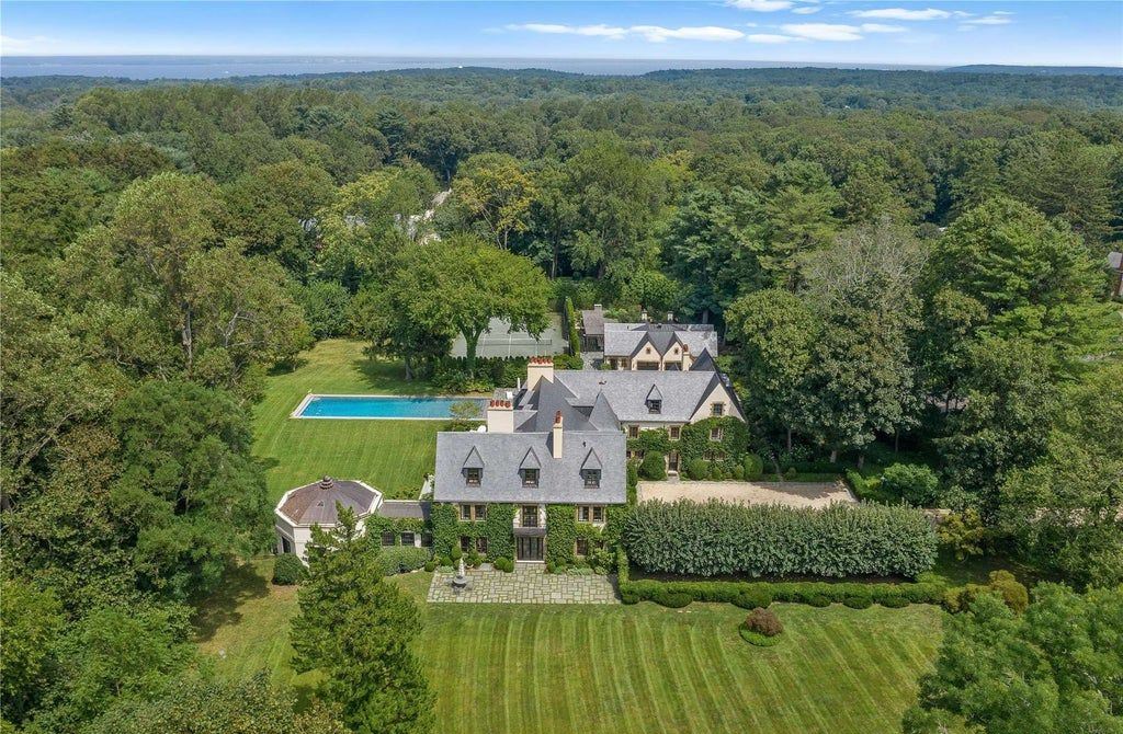 339 Duck Pond Road, Locust Valley, New York is a one of a kind home originally built in 1926 in the prestigious Village of Matinecock with exceptional amenities including a pool, pool house, tennis court, outdoor kitchen, gardens and terraces. elevator, nest system, 3,000 bottle wine cellar, art studio and more.