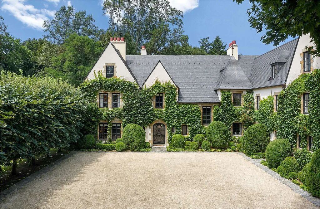 339 Duck Pond Road, Locust Valley, New York is a one of a kind home originally built in 1926 in the prestigious Village of Matinecock with exceptional amenities including a pool, pool house, tennis court, outdoor kitchen, gardens and terraces. elevator, nest system, 3,000 bottle wine cellar, art studio and more.