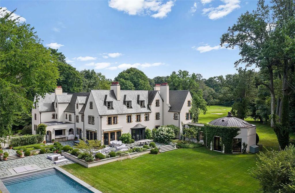339 Duck Pond Road, Locust Valley, New York is a one of a kind home originally built in 1926 in the prestigious Village of Matinecock with exceptional amenities including a pool, pool house, tennis court, outdoor kitchen, gardens and terraces. elevator, nest system, 3,000 bottle wine cellar, art studio and more.