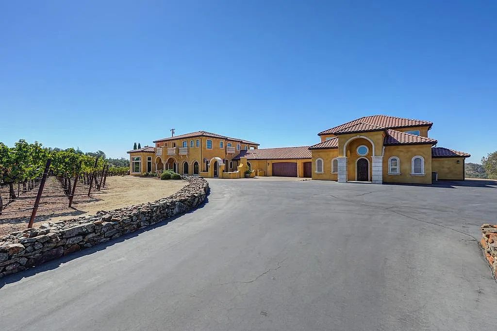 100 Shultz Vineyard Road, Shingle Springs, California is an architectural masterpiece overlooks a gorgeous working vineyard including state of the art appliances, high-end fixtures and finishes, custom iron works, and hand carved marble fireplaces and soaking tub.