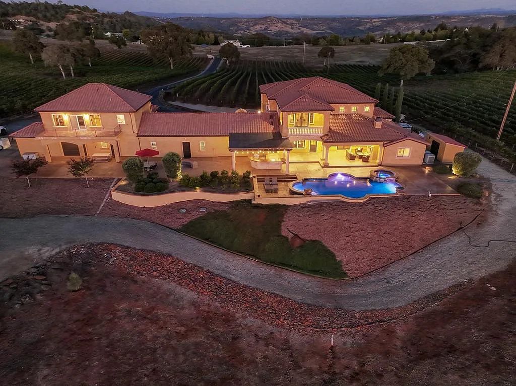100 Shultz Vineyard Road, Shingle Springs, California is an architectural masterpiece overlooks a gorgeous working vineyard including state of the art appliances, high-end fixtures and finishes, custom iron works, and hand carved marble fireplaces and soaking tub.