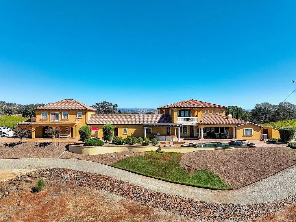 100 Shultz Vineyard Road, Shingle Springs, California is an architectural masterpiece overlooks a gorgeous working vineyard including state of the art appliances, high-end fixtures and finishes, custom iron works, and hand carved marble fireplaces and soaking tub.