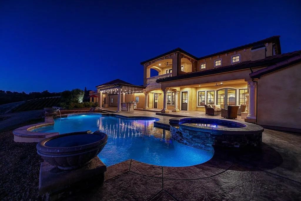 100 Shultz Vineyard Road, Shingle Springs, California is an architectural masterpiece overlooks a gorgeous working vineyard including state of the art appliances, high-end fixtures and finishes, custom iron works, and hand carved marble fireplaces and soaking tub.