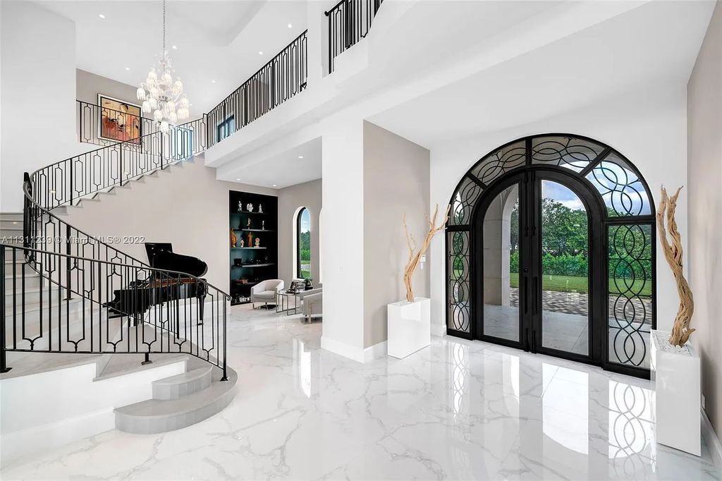 5875 Stone Creek Way, Fort Lauderdale, Florida, built by acclaimed builder Rick Bell, sits on 5 acres and boasts over 20,000 square feet of space. This incredible and one-of-a-kind custom compound's grand estate, including private gates, features volume ceilings, a resort-style pool, and top-of-the-line appliances.