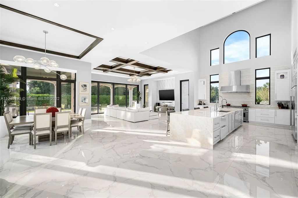 5875 Stone Creek Way, Fort Lauderdale, Florida, built by acclaimed builder Rick Bell, sits on 5 acres and boasts over 20,000 square feet of space. This incredible and one-of-a-kind custom compound's grand estate, including private gates, features volume ceilings, a resort-style pool, and top-of-the-line appliances.