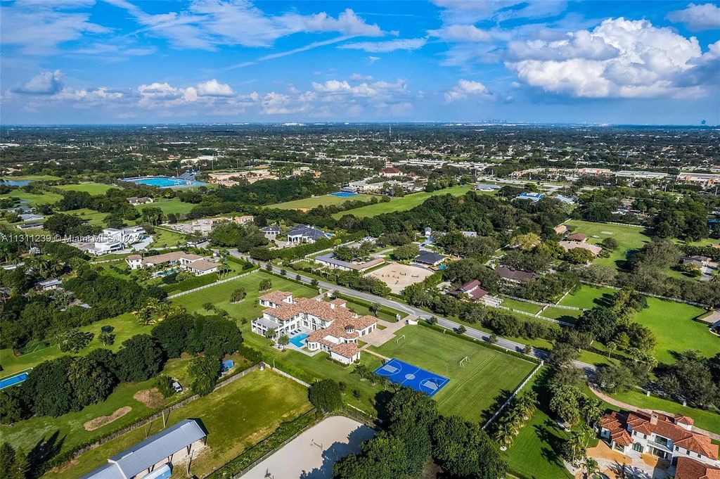 5875 Stone Creek Way, Fort Lauderdale, Florida, built by acclaimed builder Rick Bell, sits on 5 acres and boasts over 20,000 square feet of space. This incredible and one-of-a-kind custom compound's grand estate, including private gates, features volume ceilings, a resort-style pool, and top-of-the-line appliances.