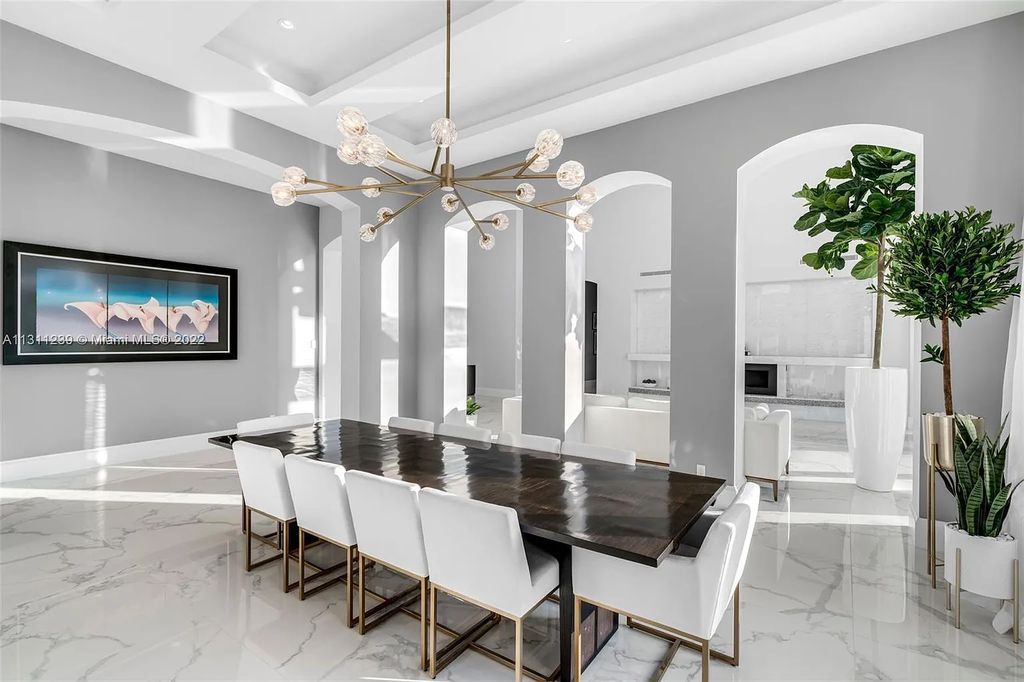 5875 Stone Creek Way, Fort Lauderdale, Florida, built by acclaimed builder Rick Bell, sits on 5 acres and boasts over 20,000 square feet of space. This incredible and one-of-a-kind custom compound's grand estate, including private gates, features volume ceilings, a resort-style pool, and top-of-the-line appliances.