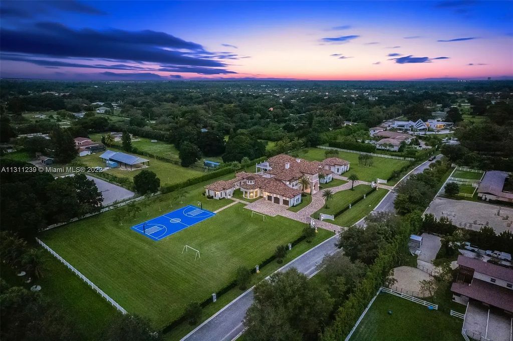 5875 Stone Creek Way, Fort Lauderdale, Florida, built by acclaimed builder Rick Bell, sits on 5 acres and boasts over 20,000 square feet of space. This incredible and one-of-a-kind custom compound's grand estate, including private gates, features volume ceilings, a resort-style pool, and top-of-the-line appliances.