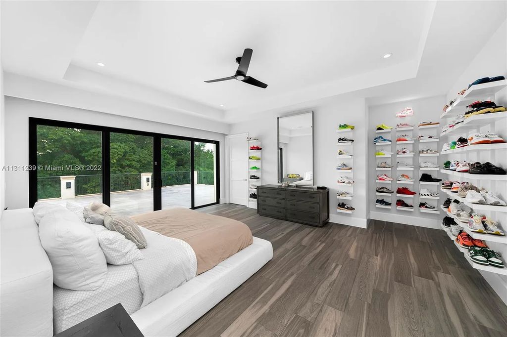 5875 Stone Creek Way, Fort Lauderdale, Florida, built by acclaimed builder Rick Bell, sits on 5 acres and boasts over 20,000 square feet of space. This incredible and one-of-a-kind custom compound's grand estate, including private gates, features volume ceilings, a resort-style pool, and top-of-the-line appliances.